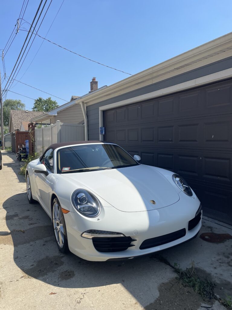 White sports car parked in driveway
